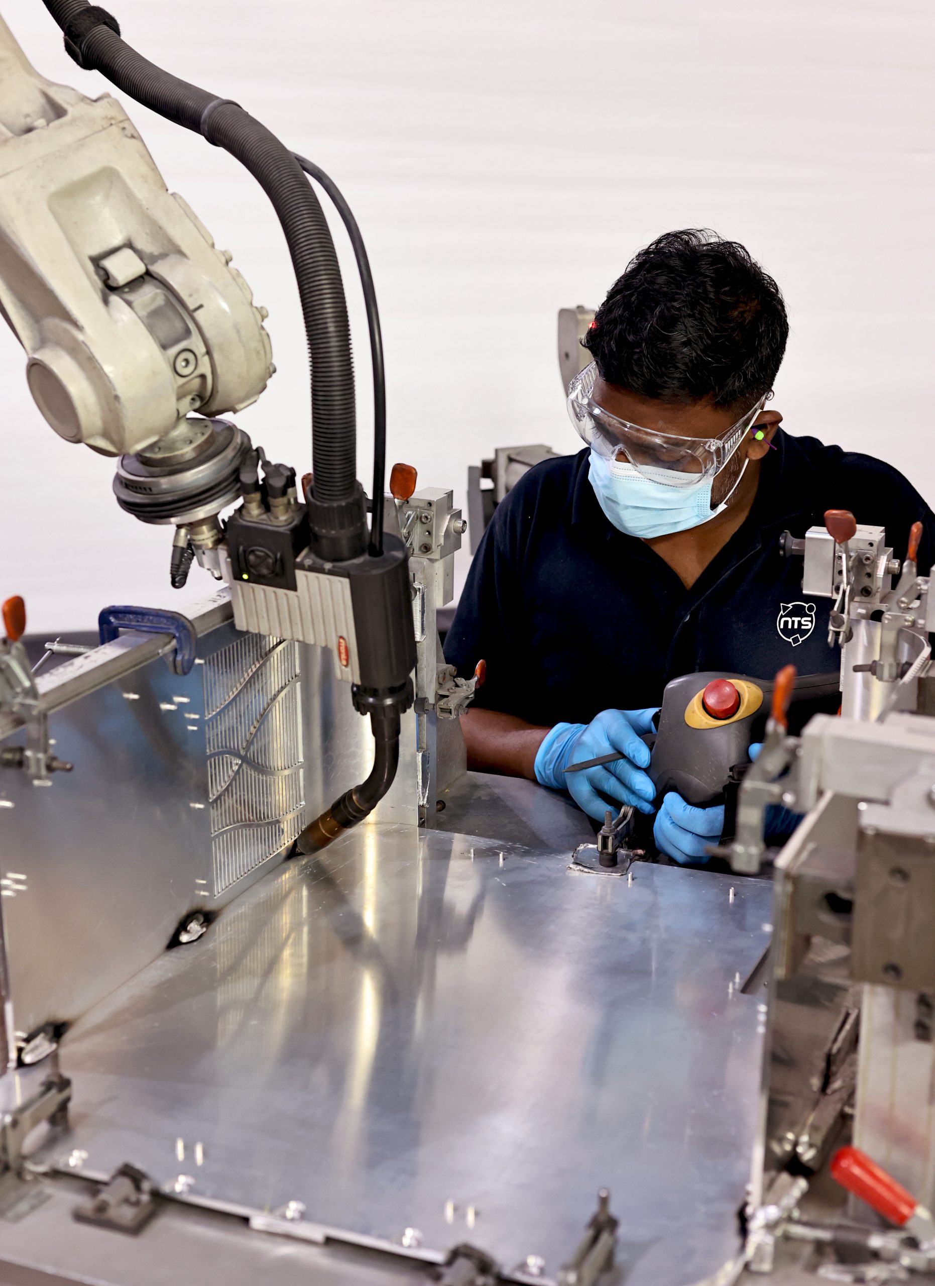 NTS Singapore employee working with machine for mechatronics and mechanics